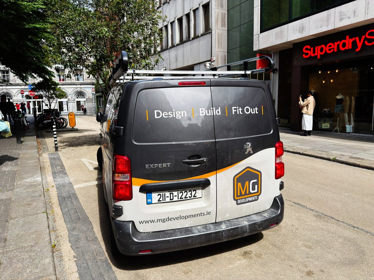 Company van outside shops on a UK high street