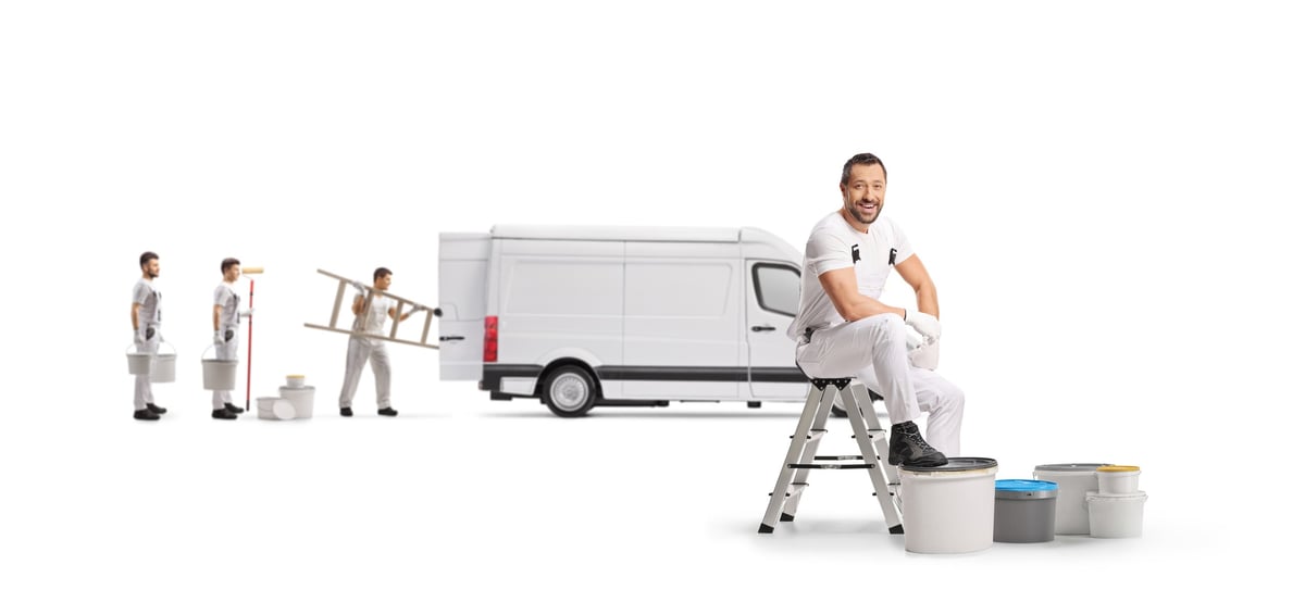 Painters unloading equipment from a delivery van on site